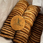 Stack of round mini stroopwafel cookies  featuring a logo on a light background
